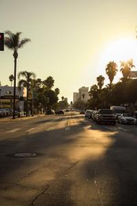 an empty street with cars parked on the side of the road at Fruit Hostel in Los Angeles