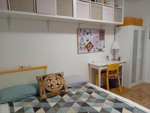 a bedroom with a bed and a desk and a table at Ka'Luzy in Santa Ana