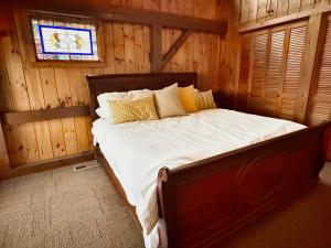 a bedroom with a bed in a wooden cabin at Fox's Den Your Lakefront Escape with Dock and Stunning Views in Rocky Mount