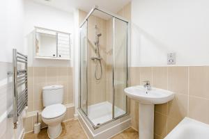 a bathroom with a shower toilet and a sink at Modern 2 Bedroom House in Cheshunt in Cheshunt +7 photos