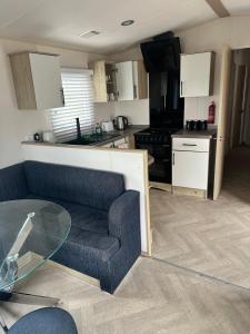 a living room with a couch and a kitchen at Moonstone in Lossiemouth +6 photos