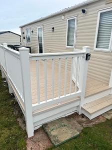 a white fence on a deck in front of a house at Moonstone in Lossiemouth