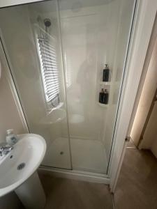 a bathroom with a shower and a sink at Moonstone in Lossiemouth