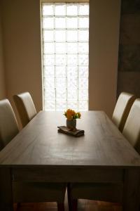 a dining room table with a vase of flowers on it at BGD Rentals in Donji Milanovac +6 photos
