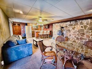 a living room with a stone wall and a table and chairs at Fox's Den Your Lakefront Escape with Dock and Stunning Views in Rocky Mount