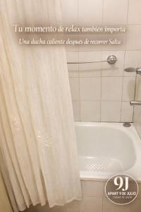 a bathroom with a shower curtain and a bath tub at Apart 9 de julio in Salta