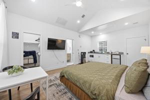 a bedroom with a bed and a table and a kitchen at The Right Studio @ East Downtown in Houston