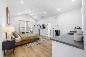 a white room with a bed and a kitchen at The Right Studio @ East Downtown in Houston