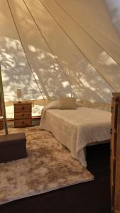 a bedroom with a bed in a tent at Finca los ciervos in Apan +36 photos