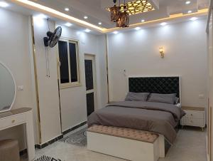a bedroom with a large bed and a mirror at Nour House in Luxor +35 photos