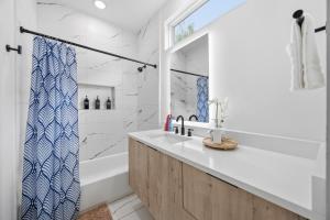 a bathroom with a white tub and a sink at The Right Studio @ East Downtown in Houston +18 photos