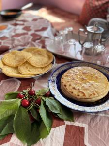 a table with two plates of food on it at Azadne in Oulad Akkou