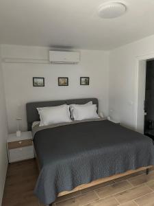 a bedroom with a bed with a black comforter at Villa AMULET - Spacious 3BR Villa near Postojna Cave in Postojna