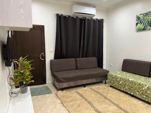 a living room with a couch and a black curtain at Waiyavi Apartments in Lautoka