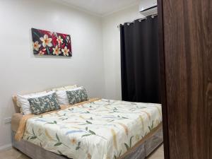a bedroom with a bed and a black curtain at Waiyavi Apartments in Lautoka