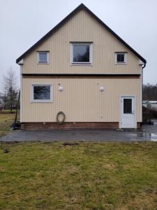 a large house with a white door at Yellow house in Skene