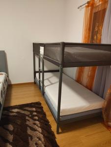 a black bunk bed in a room with a rug at Leiria Tranquil Hideaway in Leiria