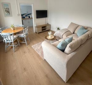 a living room with a couch and a table at Cornish coastal escape in Bude in Bude