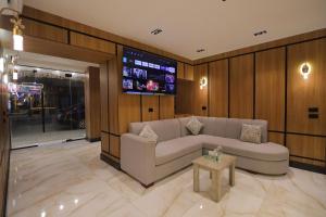 a living room with a couch and a table at Locanda Pyramids Hotel in Cairo