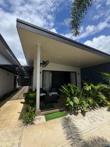 a modern home with a patio and a house at El Jardín de Martín in Puerto Jiménez