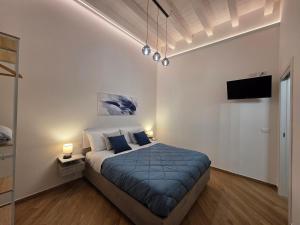 a bedroom with a bed and a flat screen tv at Marèa in Porticello