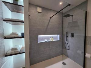 a bathroom with a shower with a glass door at Marèa in Porticello