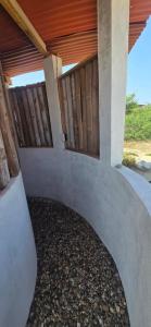 a porch of a house with a wooden fence at Chacahua Cabañas LAUD in Guayabas