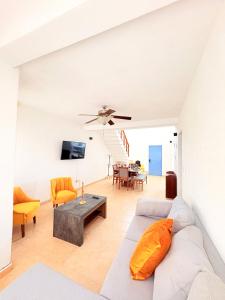 a living room with a couch and a table at Estrella Azul Penthouse in Cancún