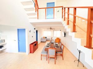 a living room with a long table and chairs at Estrella Azul Penthouse in Cancún