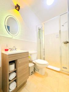 a bathroom with a toilet and a sink and a shower at Estrella Azul Penthouse in Cancún +15 photos
