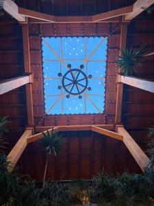 a large window in a wooden building with a wheel at Hotel Spa Mansion Santa Isabella in Riobamba