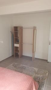 a room with a bed and a refrigerator in it at Appartement Ti Coquelicot in Rivière-Salée