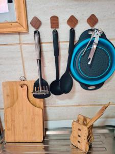 a bunch of kitchen utensils hanging on a wall at Tiny House Luogo Di Riposo in El Tabo