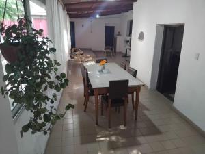 a dining room with a white table and chairs at Casona Estación Cabra Corral in Coronel Moldes