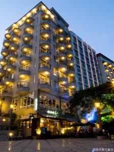 a large building with windows and lights on it at Shui Sha Lian Hotel - Harbor Resort in Yuchi