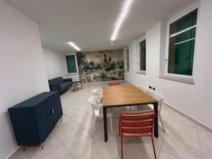 a dining room with a table and chairs at Nuvole e Miracoli - foresteria in Bagnolo Mella