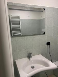 a bathroom with a sink and a mirror at Nuvole e Miracoli - foresteria in Bagnolo Mella