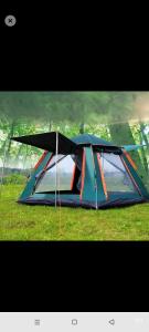 a tent sitting on the grass in a field at Laminas beach camp in Kilifi