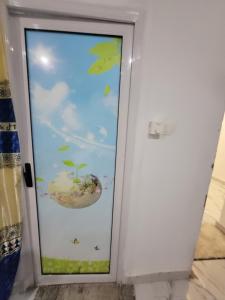 a door with a window with a picture of an aquarium at DALENT RESiDENCE in Brusubi +2 photos
