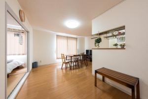 a living room with a bench and a table at アルカディアｋ in Aomori +30 photos