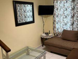 a living room with a couch and a window at Casa Canaan in Monterrey