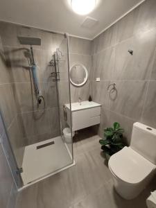 a bathroom with a shower and a toilet and a sink at Wild Platypus Stays in Eungella +23 photos