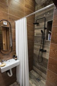a bathroom with a shower curtain and a sink at Cozy in Sarajevo +27 photos