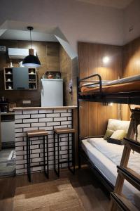 a room with a bunk bed and two stools at Cozy in Sarajevo