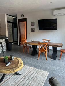 a living room with a wooden table and chairs at D&B apartments in Lo de Marcos