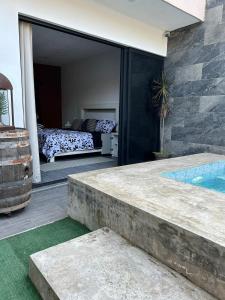 a house with a bedroom and a swimming pool at D&B apartments in Lo de Marcos