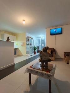 a living room with a statue on a table at Hotel CasaBlanca"Tablon de miraflores" in Cuenca