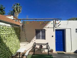 a house with a blue door and a bench at Tlaxcala Apartment # 5 in Ciudad Obregón