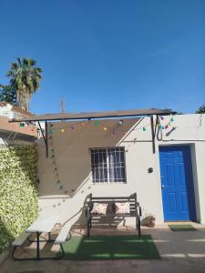 a house with a blue door and a bench at Tlaxcala Apartment # 5 in Ciudad Obregón +5 photos