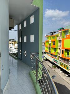 a balcony of a building with colorful buildings at Nhà nghỉ Thu Hoạch in Hà Tiên